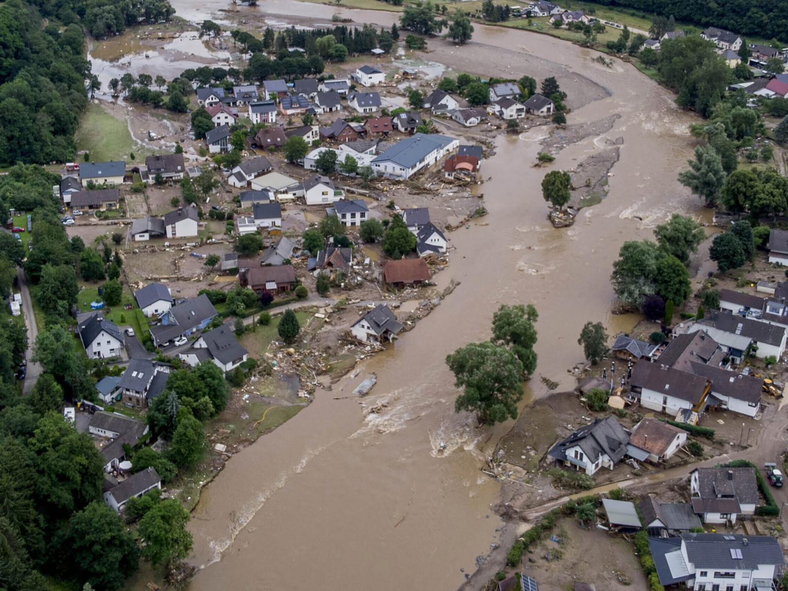 The Ahr river flows past houses destroyed by floods in Germany in July.