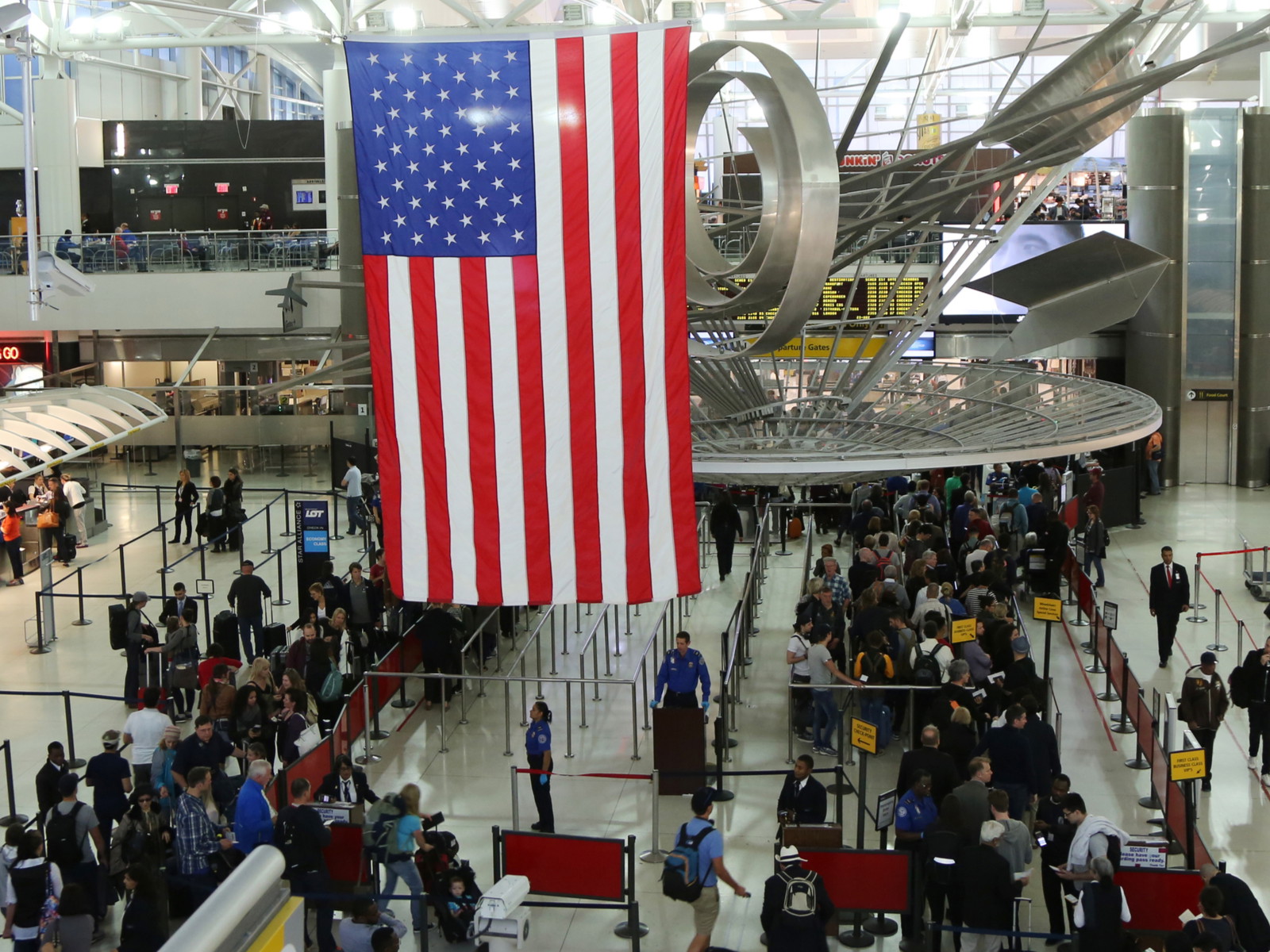 Travellers queuing at JFK International Airport in New York.