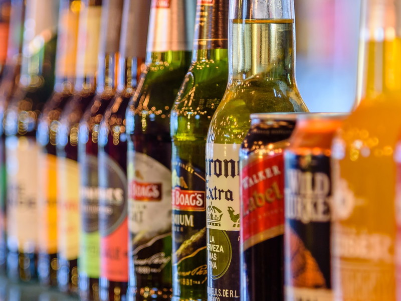Bottles and cans of alcoholic drinks on display.