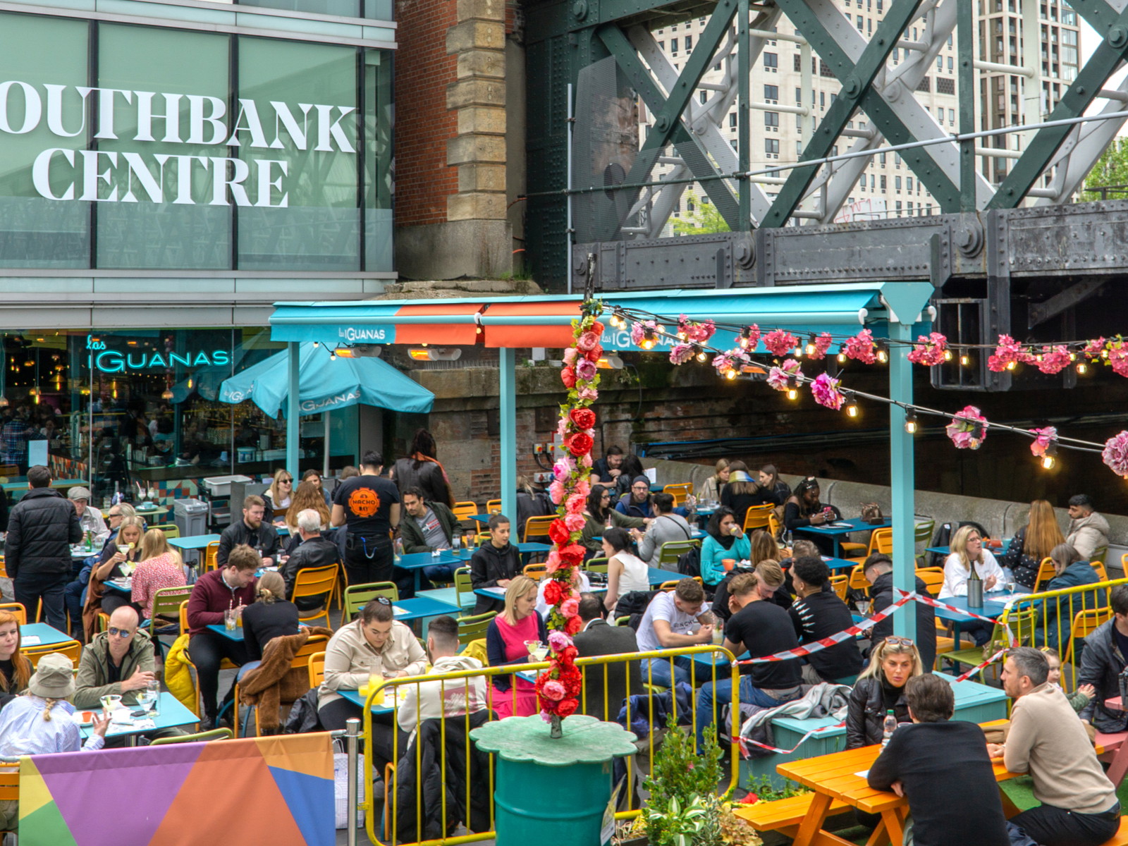 Customers dining out on a terrace near the Thames in London.&nbsp;