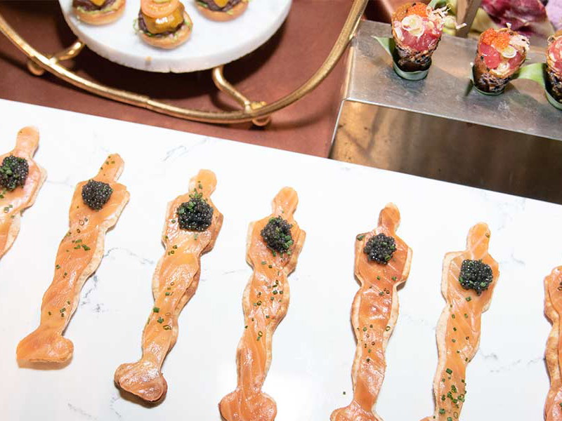 Smoked salmon and caviar play a leading role in Wolfgang Puck's famous pizza.