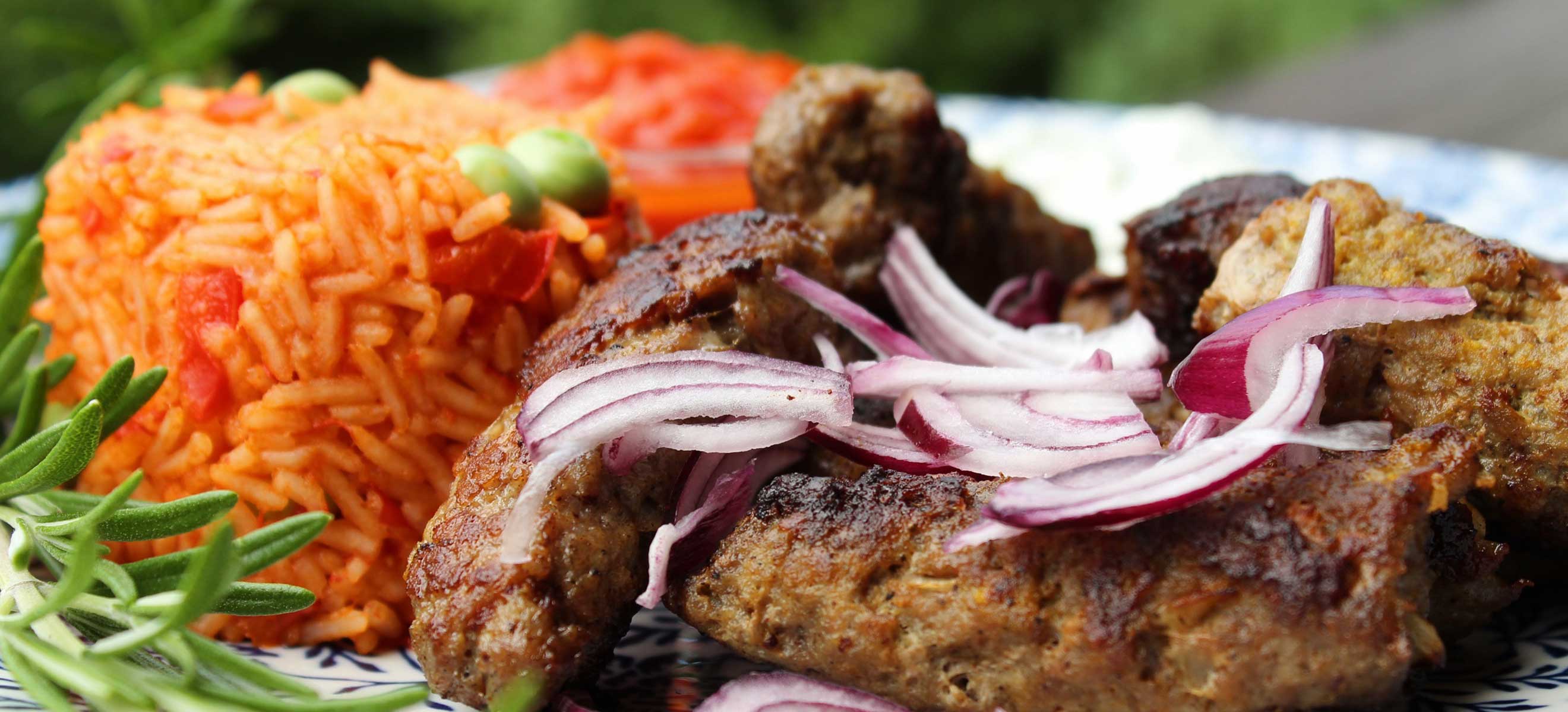 Ćevapčići or grilled Balkan meatballs served with rice.