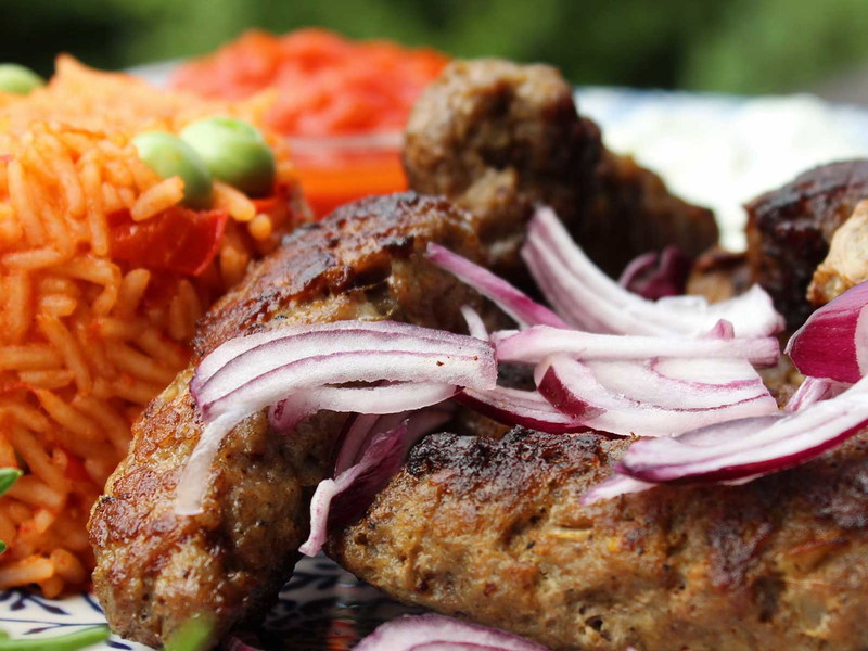 Ćevapčići or grilled Balkan meatballs served with rice.
