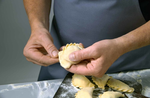 Now "crimp" the noodles. Fold over a small piece, press tightly, fold over, press tightly - until an even crimped edge is formed.