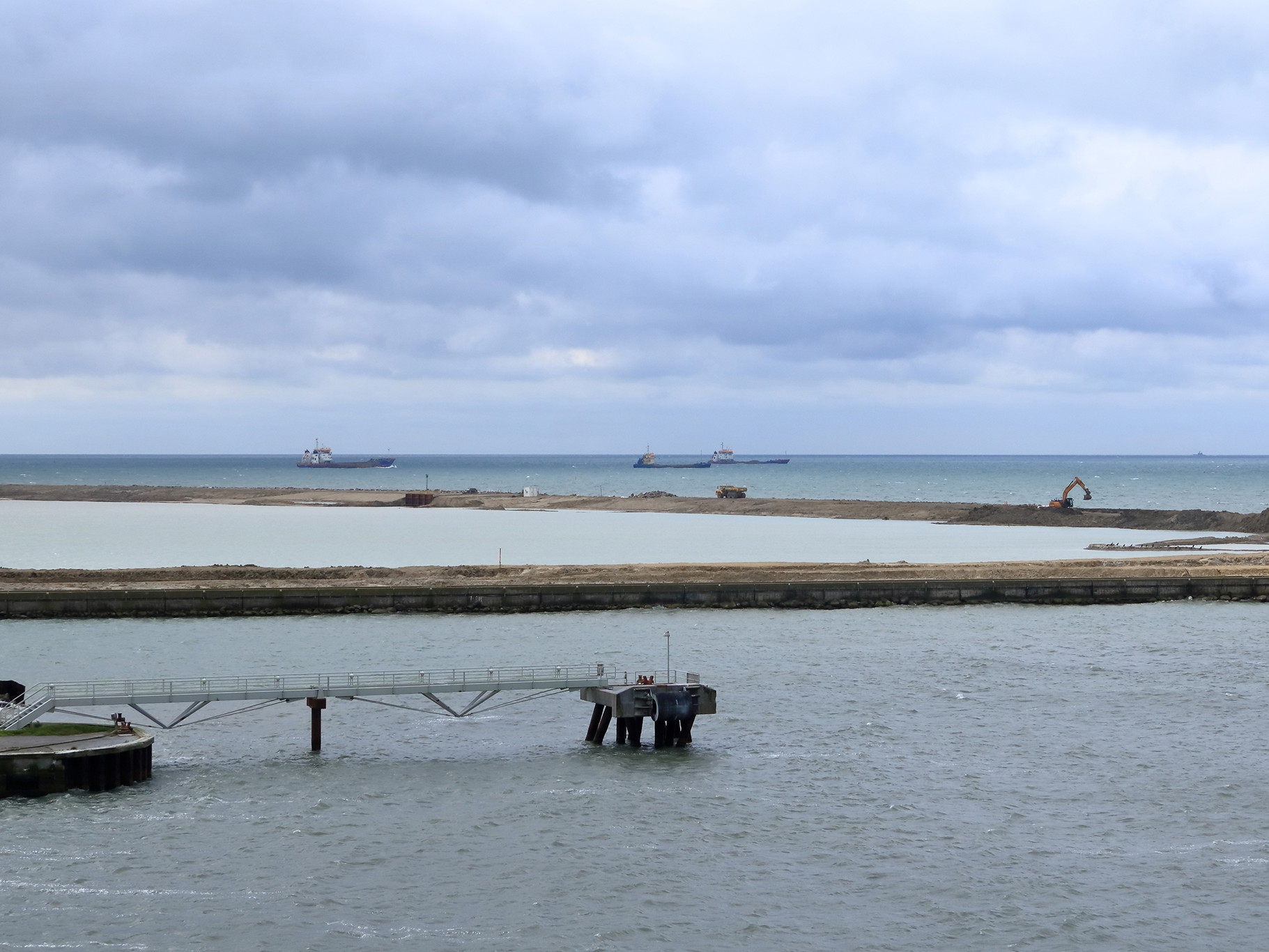 Cranes and excavators are working at a new port facility for the Fehmarnbelt Tunnel Link project.