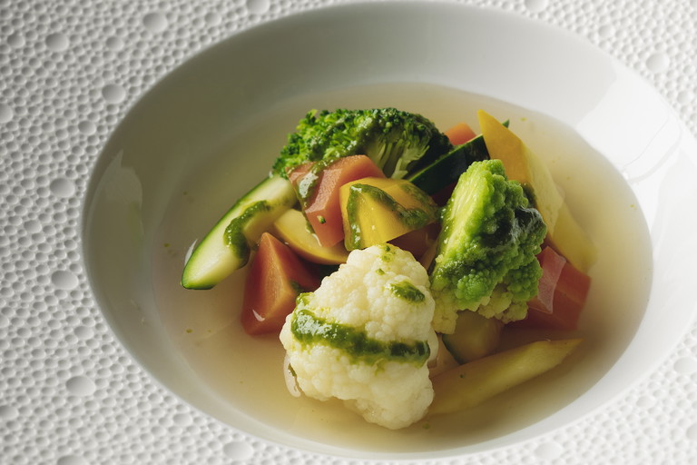 Traditional vegetable soup with herb oil.