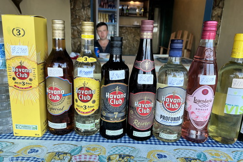 Roadside sales of rum at 50% discount from official prices.