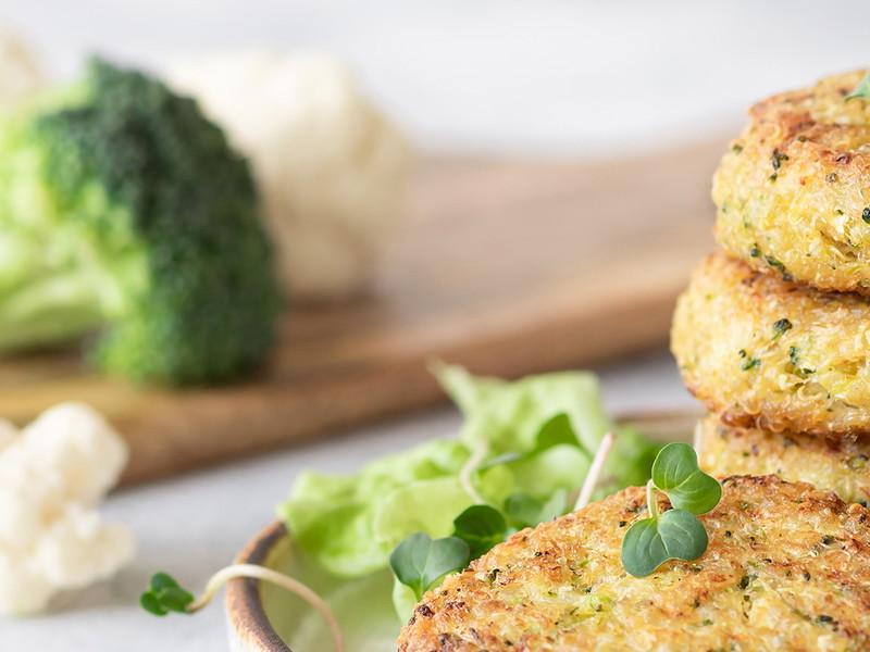 veggie burgers with quinoa, broccoli, cauliflower served with salad. plant based food. space for text