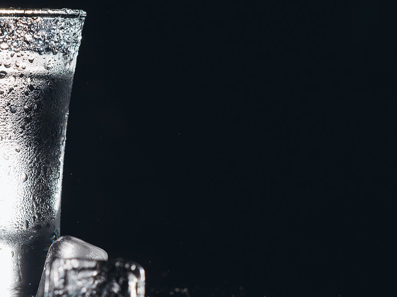 Vodka. Shots, glasses with vodka with ice .Dark background. Copy space .Selective focus
