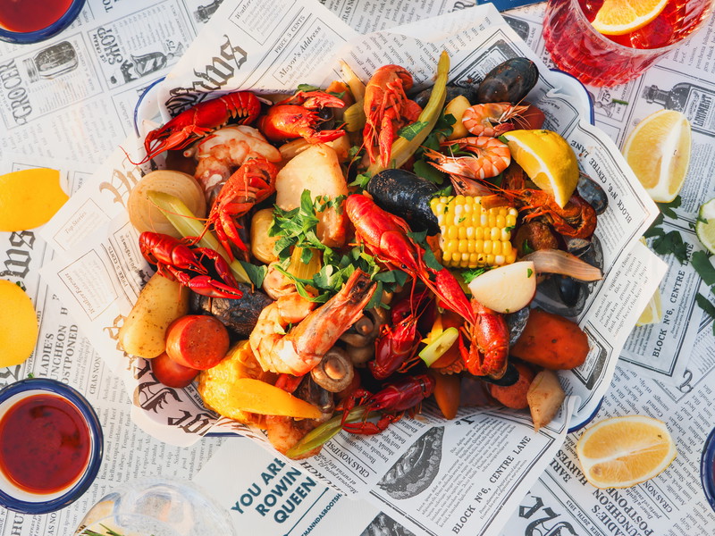 Frisch gegrillte Meeresfrüchte und Fisch beim Seafood-Boil im Bootshaus.