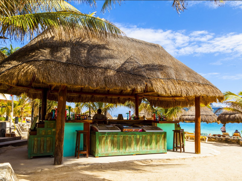 Sonne, blauer Himmel, weißer Strand, eine lässige Beachbar direkt am Meer und einen kalten Drink in der Hand: So sieht es aus, das Idealbild eines Inseltraums, bei dem der Rum natürlich nicht fehlen darf.