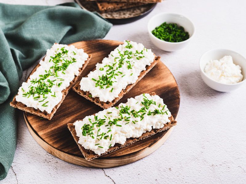 Roggen-Knäckebrot mit Hüttenkäse und Schnittlauch – ein aromatischer Snack. 