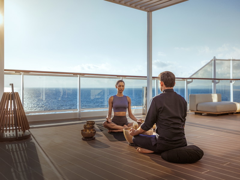 Guests on the "Explora Journeys" cruises greet the day with sunrise yoga.