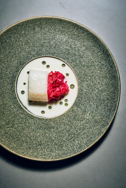 Black Cod from Monterey with pickled wild roses lactic fermented white asparagus and smoked and aged pork fat