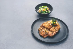 Breaded venison schnitzel with potato and lamb's lettuce salad