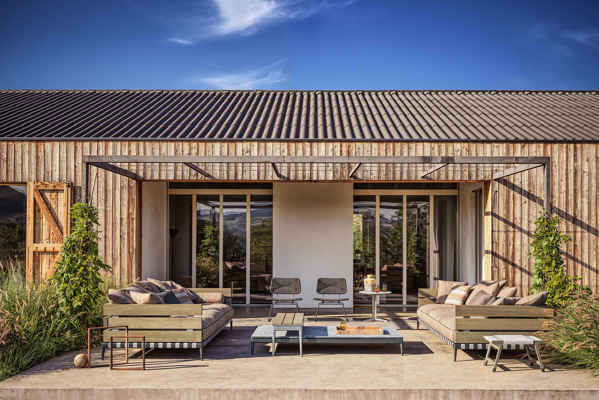 Grandemare Outdoor sofa, Fly Outdoor side table, Tessa Outdoor armchair and ottoman.