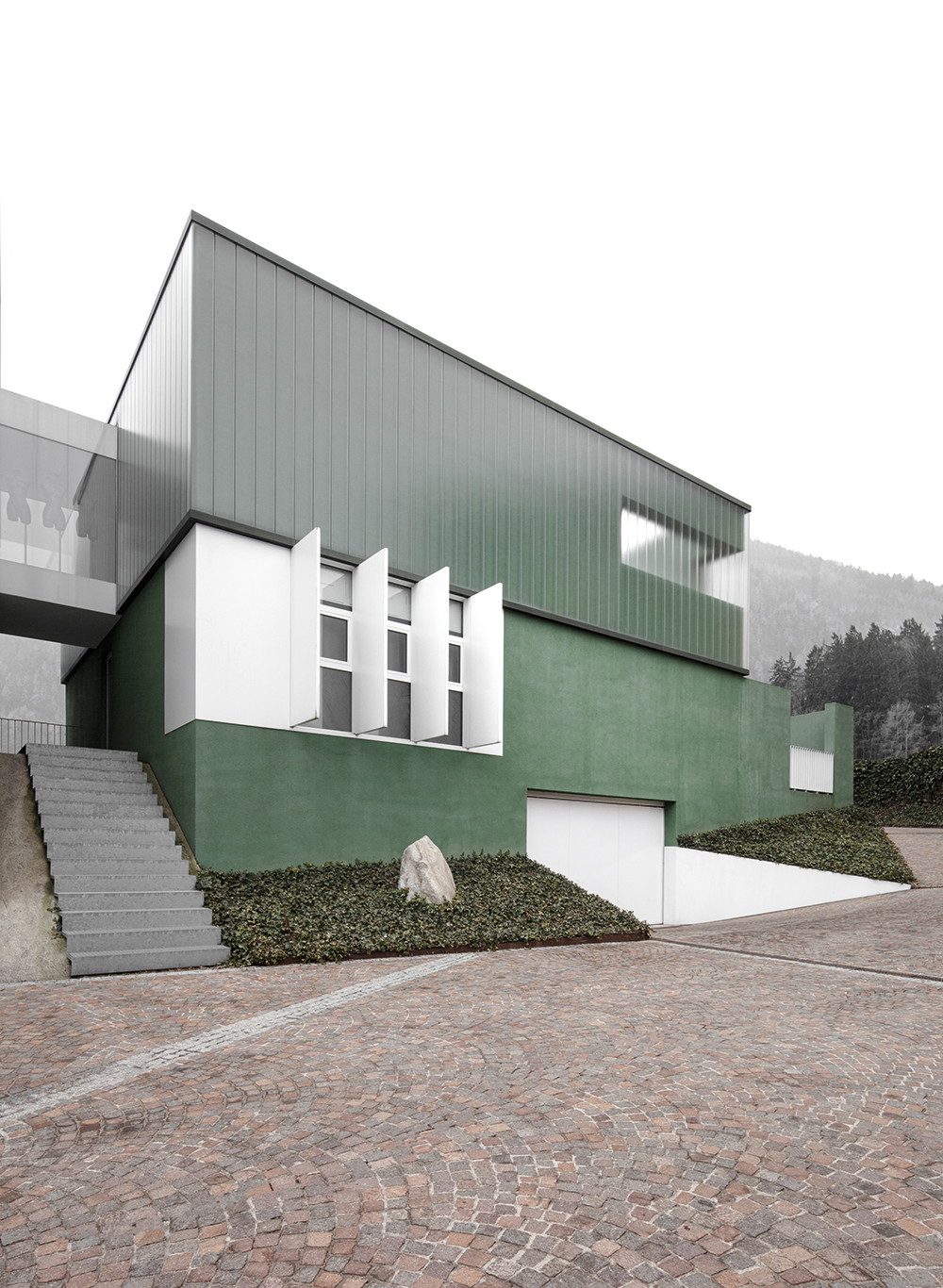 Villa R. aus Recyclingglas, Südtirol&nbsp;Der diffuse Effekt dieses Hauses ist durchaus gewollt: Das Profilglas im Obergeschoß wurde im Auftrag der Bauherrin Ruth Volgger eigens für dieses Projekt entwickelt und besteht aus recyceltem Flaschenglas. Dem grünen Putz wurden aus optischen Gründen zermahlene Glassplitter beigemischt. Dadurch funkelt und schimmert die Fassade im Sonnenlicht. Die 380&nbsp;Quadratmeter große Villa wurde zum Haus des Jahres 2020 gekürt. bergmeisterwolf.it