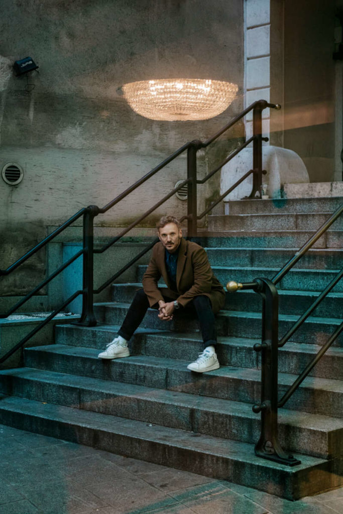 Glamouröser Schein. Der Kristallluster über dem Haupt von Martin Niedermair ist eine Spiegelung. Fotografiert durch die Glastür der Kammerspiele. Sein Erfolg ist echt und beruht auf Talent und Disziplin. 